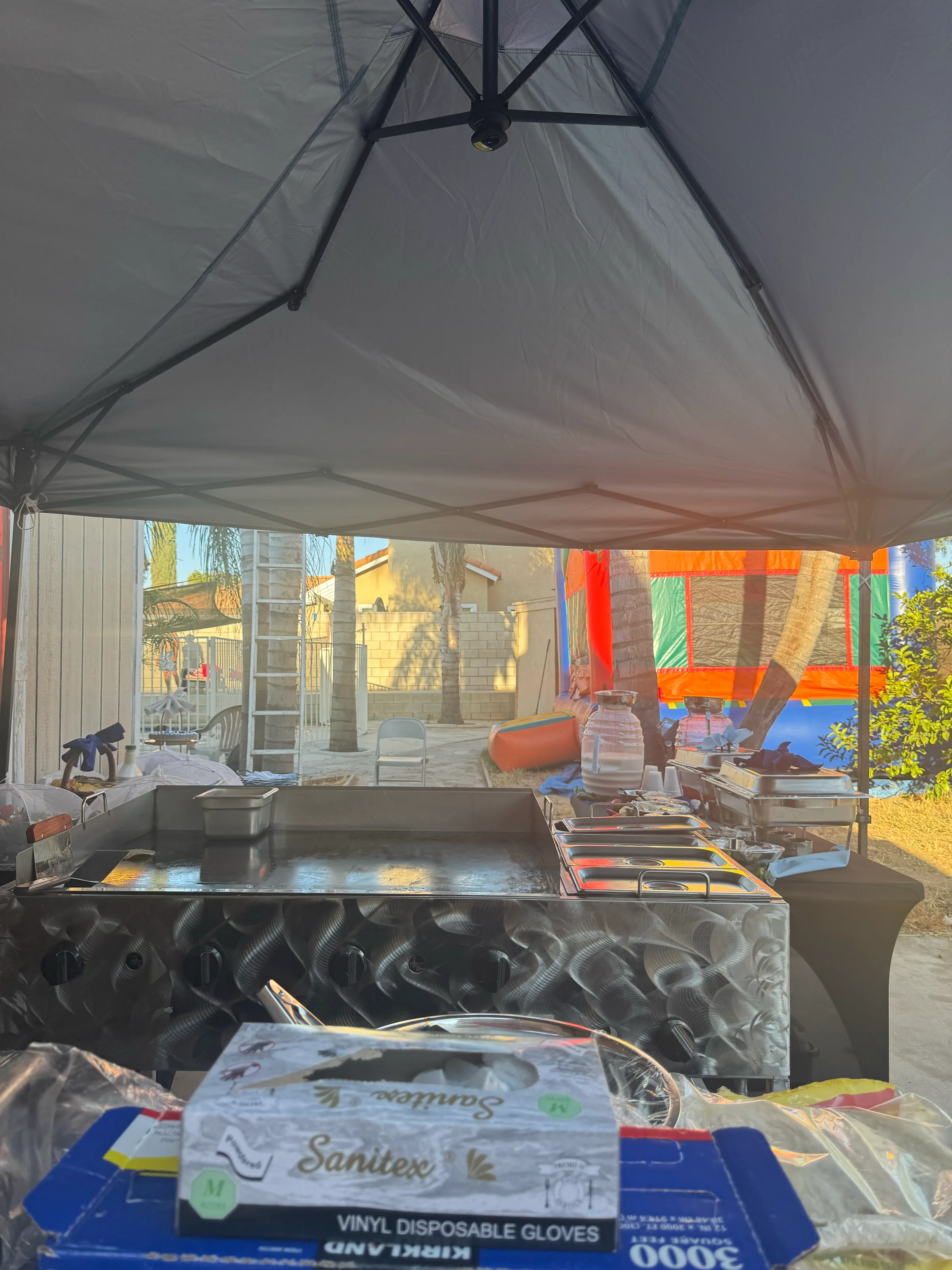 Tacos V's professional commercial griddle cart and chafing dishes set up under a canopy