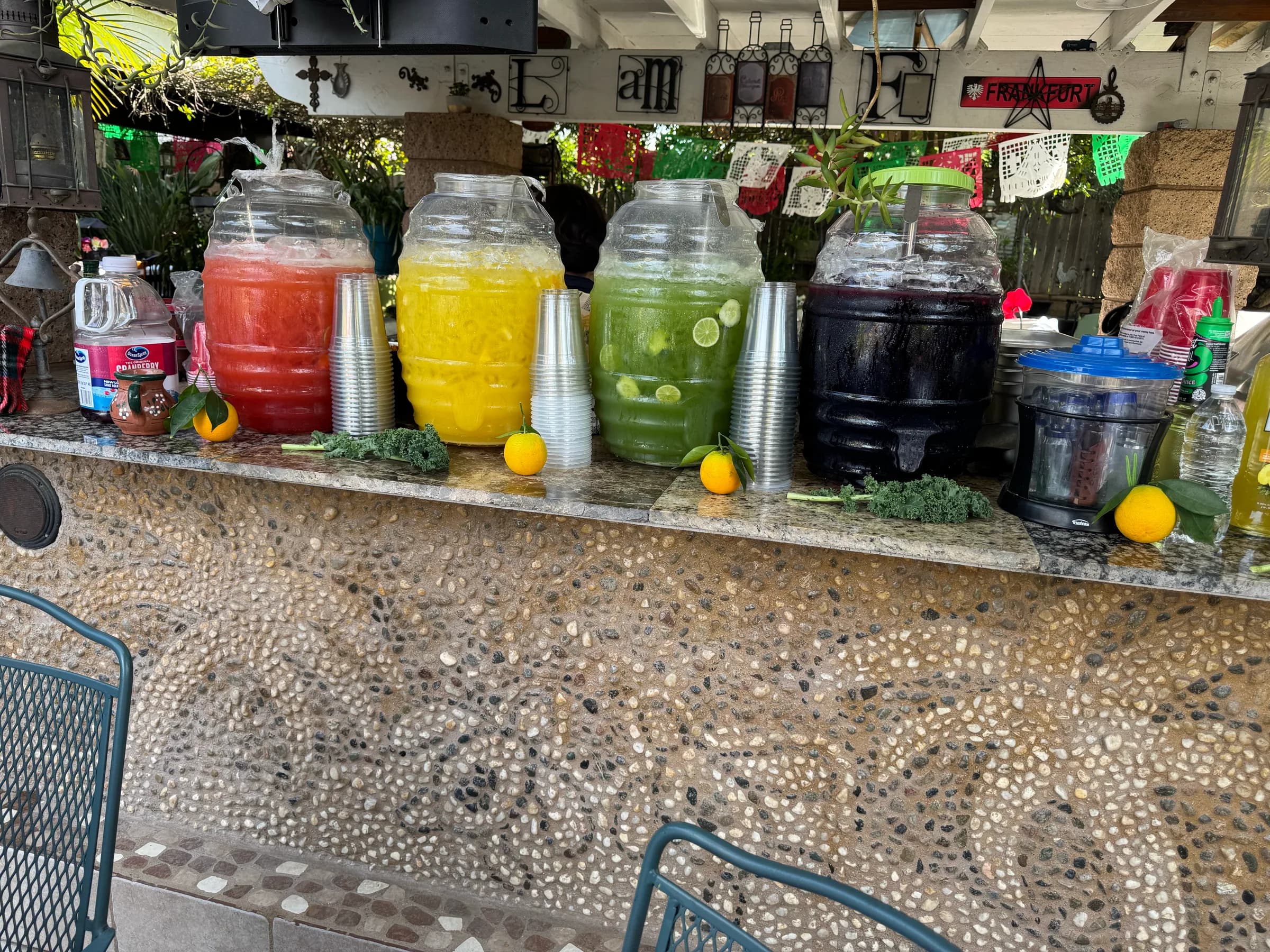 Lineup of five agua fresca flavors at a Tacos V catering event