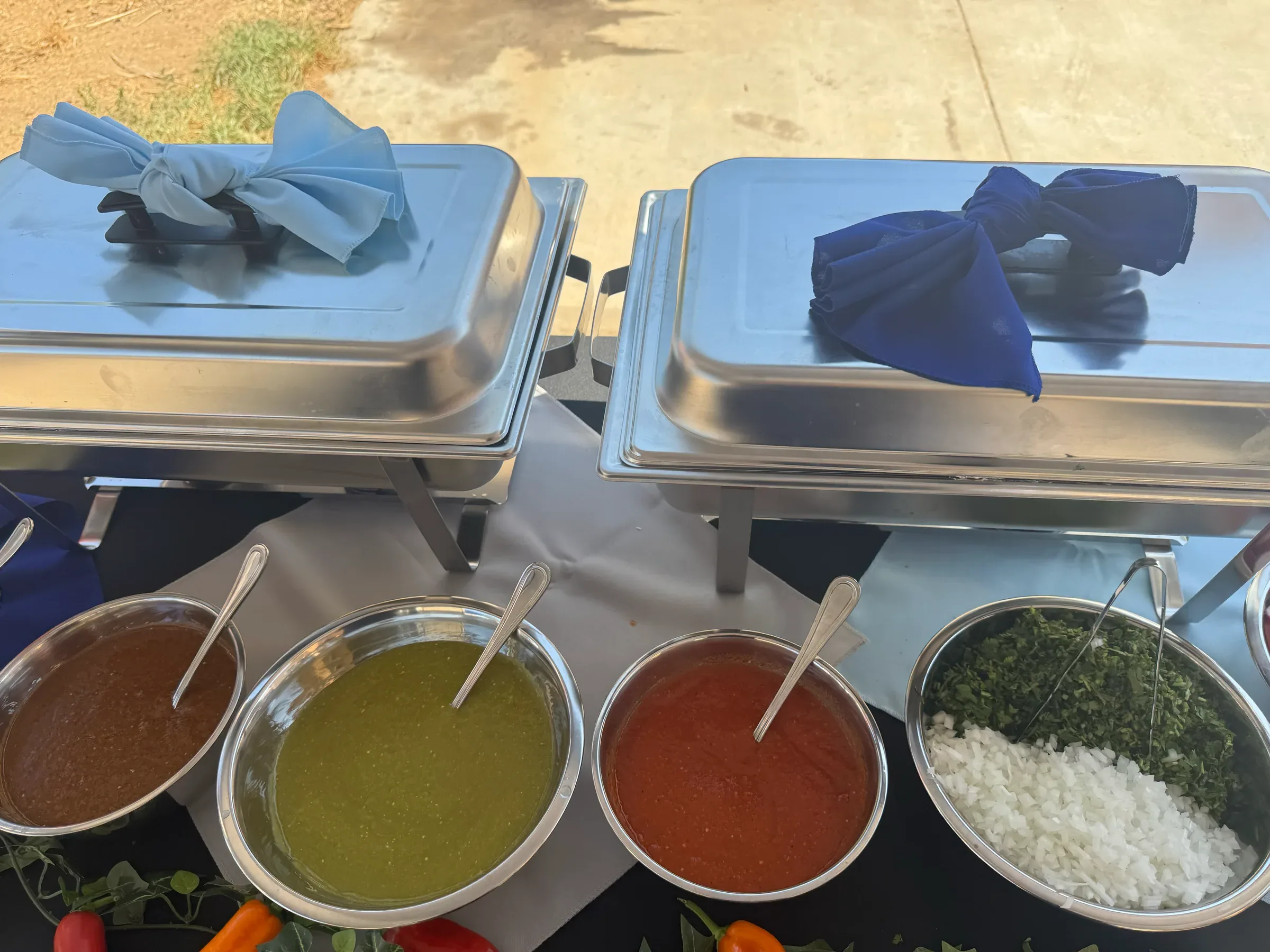 Overhead view of Tacos V's house-made salsas, red, green, and dark, with rice and cilantro